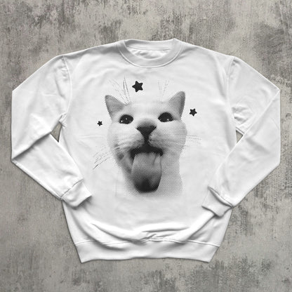 White sweatshirt with a graphic of a cat with stars on a gray surface