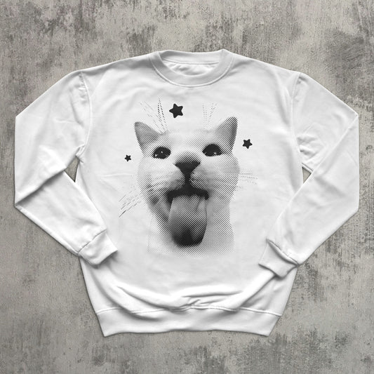 White sweatshirt with a graphic of a cat with stars on a gray surface