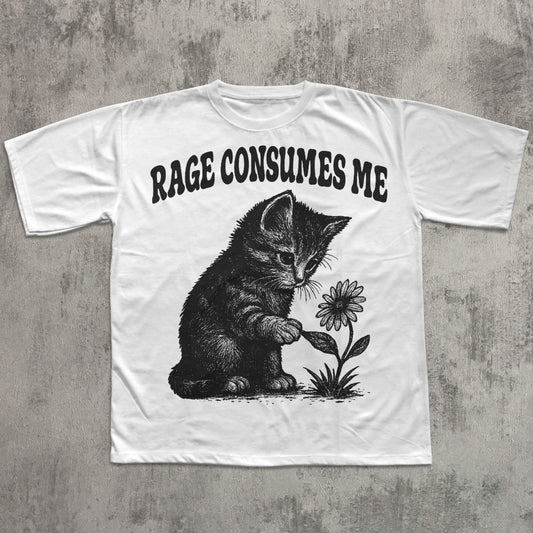 White t-shirt with a graphic of a cat holding a flower and text 'RAGE CONSUMES ME' on a concrete surface.