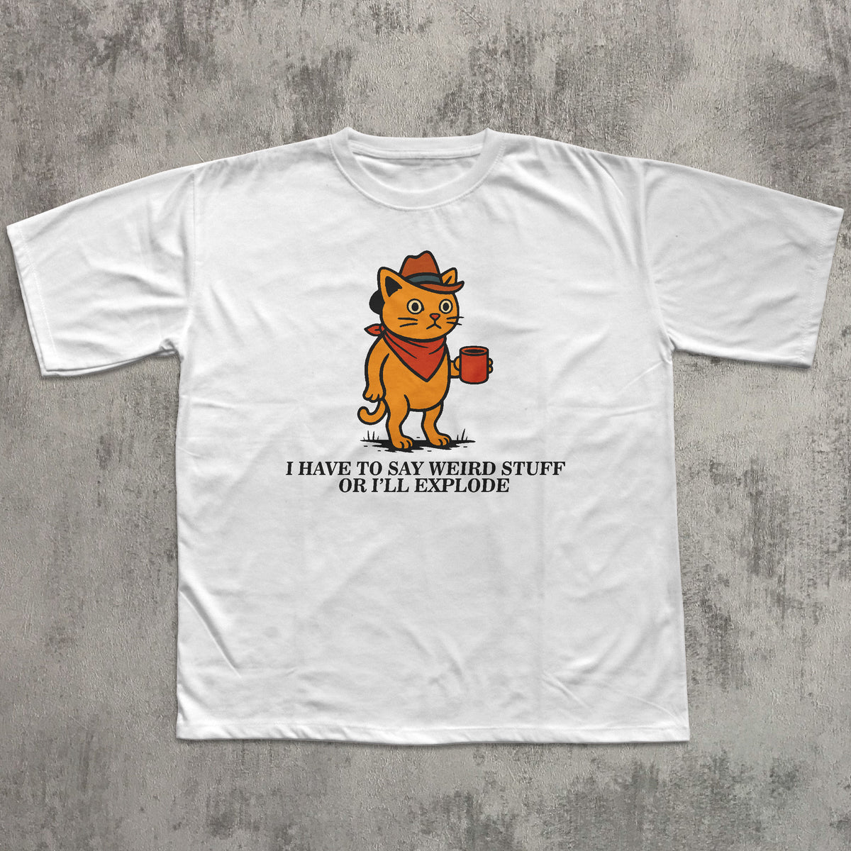White t-shirt with a cartoon cat graphic and text on a gray concrete background
