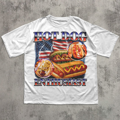 White t-shirt with hot dog graphic and 'Hot Dog Enthusiast' text on a concrete surface