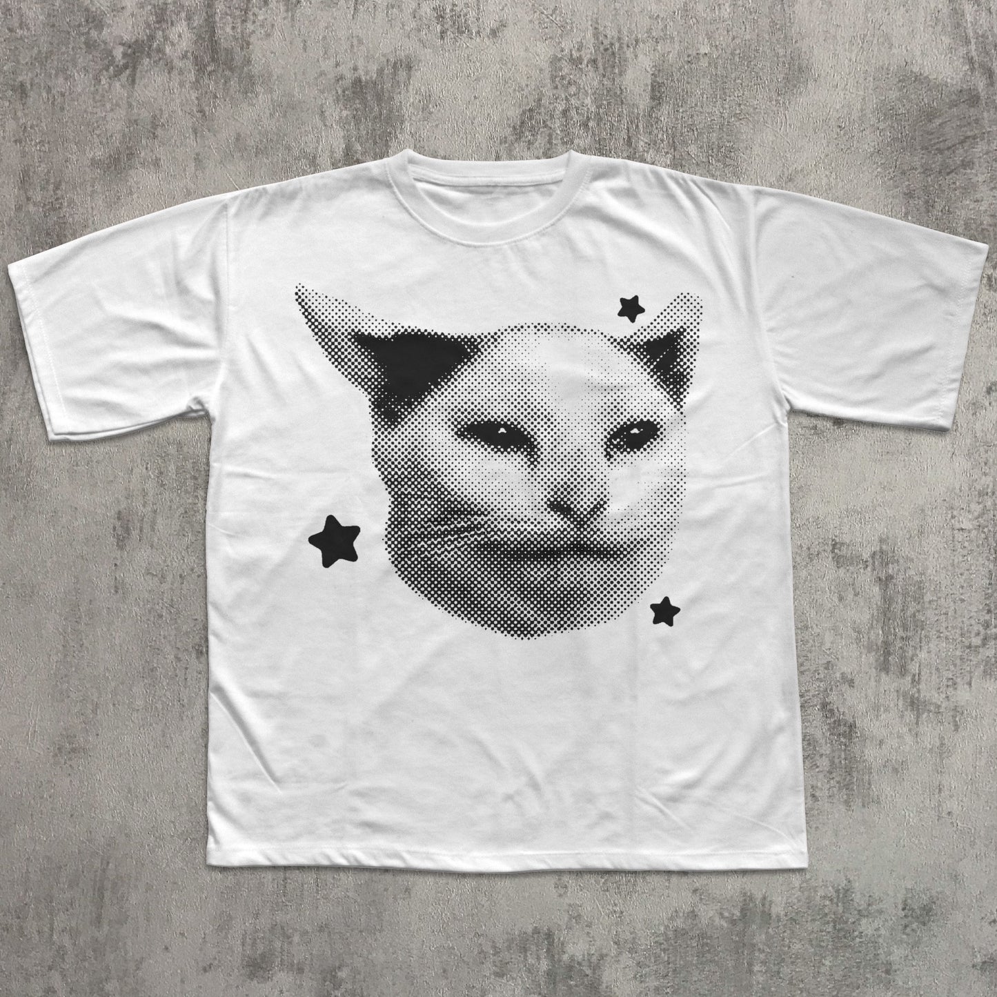 White t-shirt with a cat graphic design on a textured gray background