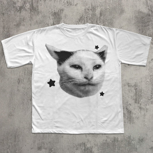 White t-shirt with a cat graphic design on a textured gray background